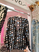 Load image into Gallery viewer, oohlala girls sheer button-down blouse with a black geometric print in blue, peach, and white on a hanger.
